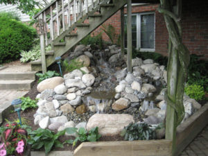 newly installed pondless waterfall under a staircase