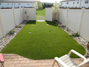 newly installed turf area inside a fenced in backyard