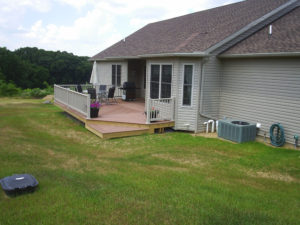 small backyard deck and grassy area