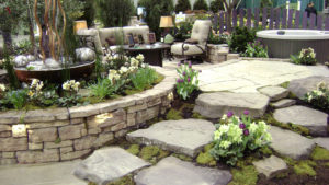 stone wall, steps, seating area and spa