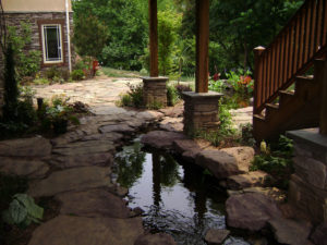 stone patio, pond, stone pillars and other backyard landscape items