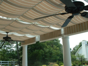 covered pergola with two overhead fans