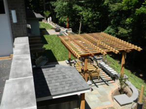 overhead view of a well landscaped backyard complete with patios, shade structures and more. the perfect outdoor living area