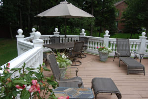 fenced in deck with patio furniture and potted flowers