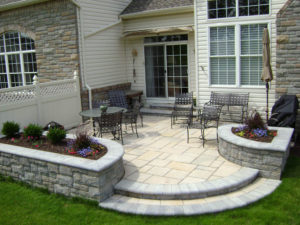 hardscaped patio with raised stone flower boxes