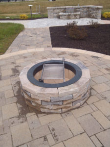 stone fire pit on a hardscaped patio