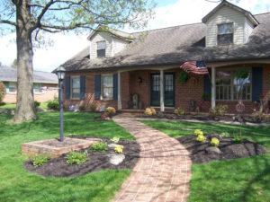 brick walkway leading up to a brick home entrance