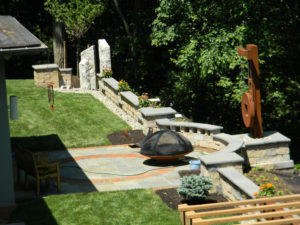 stone pillars, walls, patios, and other decorative backyard features fully display Hively's expertise