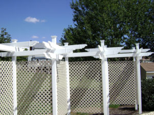 large, decorative white lattice fence