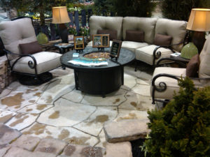 stone patio fire pit area with furniture