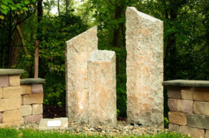 3 tier stone pillars next to stone walls
