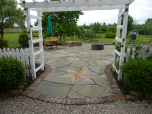 nautical star in a stone patio outlined by bricks