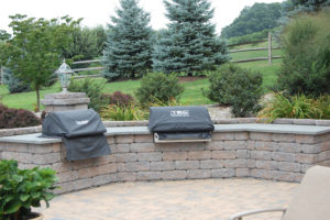 a stone wall with two built in grills