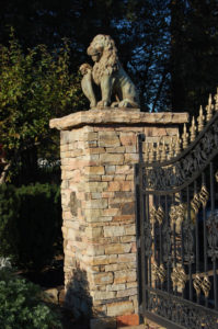 a large stone pillar with a lion statue on top