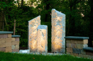 3 tier stone pillars with landscape lighting