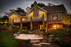 well landscaped backyard area. landscape lighting is mixed in throughout to light the home at dusk