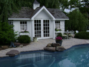 close up of a pool house next to a pool