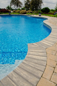 closeup of a pool and the decorative stone edging that surrounds it