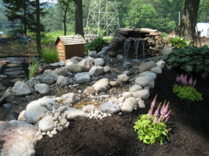 pondless waterfall with a fresh mulch bed in the foreground