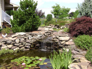 unique water feature ideas include a stone waterfall like this one