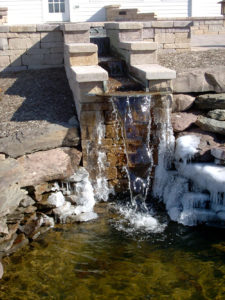 stone waterfall in the winter. ice formed on the outside stone walls