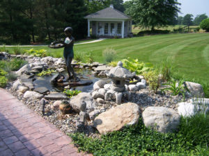 stone pond with little girl fountain