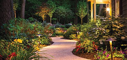 landscape services button showing a gorgeous landscaped walkway surrounded by flower beds