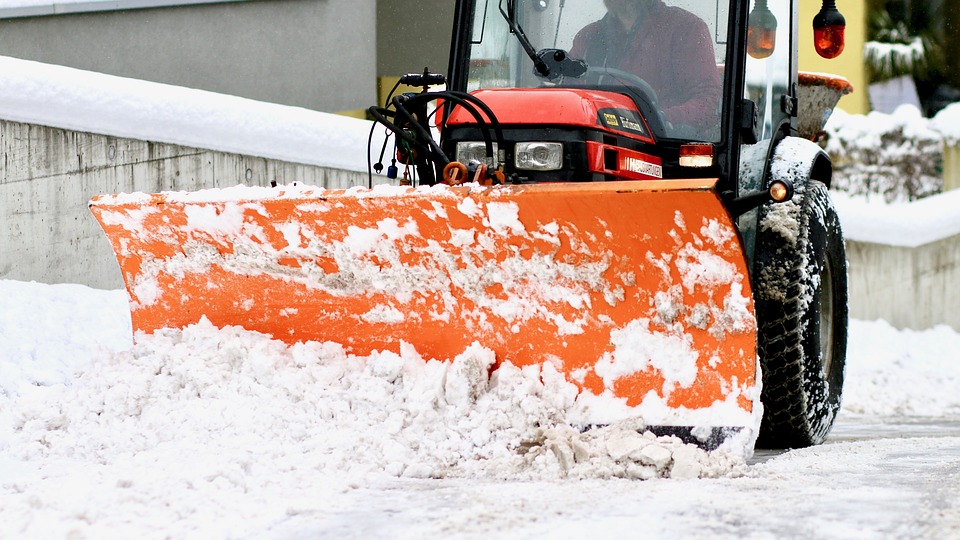 tractor plowing snow on a walkway